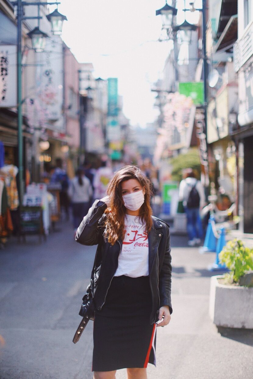 Betty Autier en tee-shirt Coca-Cola et masque dans une rue de Tokyo